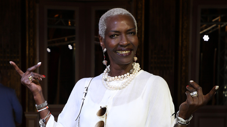Esther Kamatari wearing a white dress