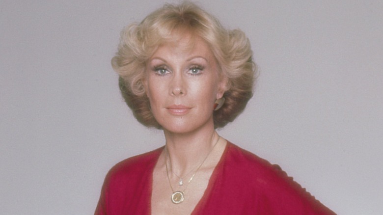 Barbara Eden with short hair and a red dress