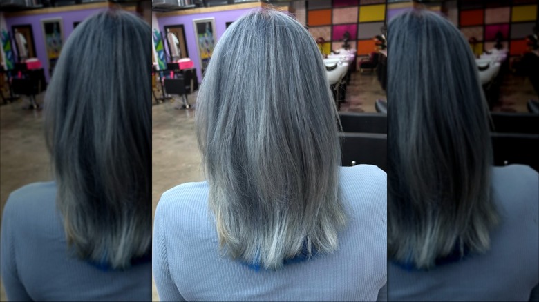A woman with gray hair that has been rinsed with blue.