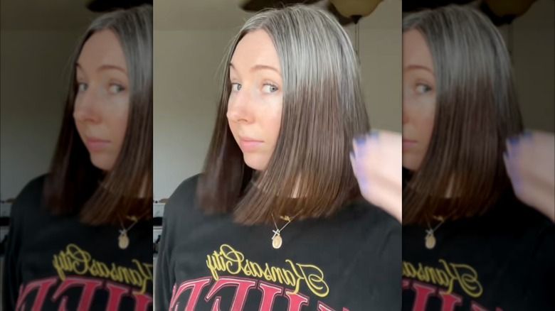 A woman with a gray roots ombré