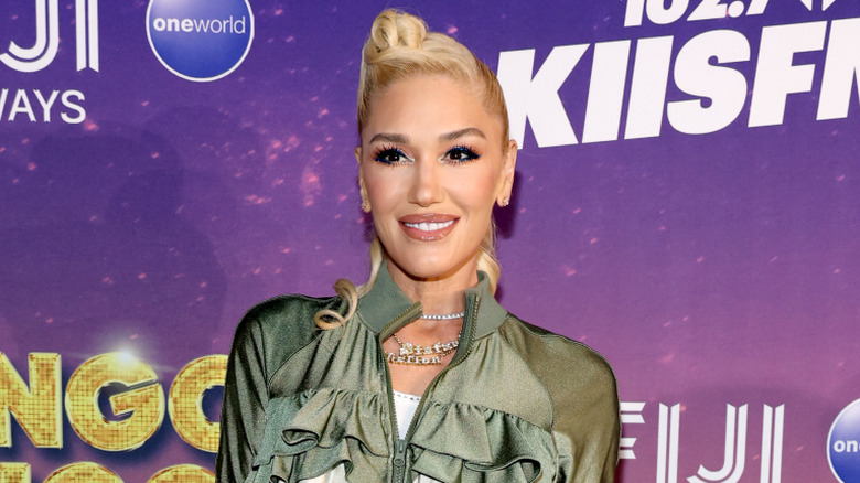 Gwen Stefani smiling with a blond updo