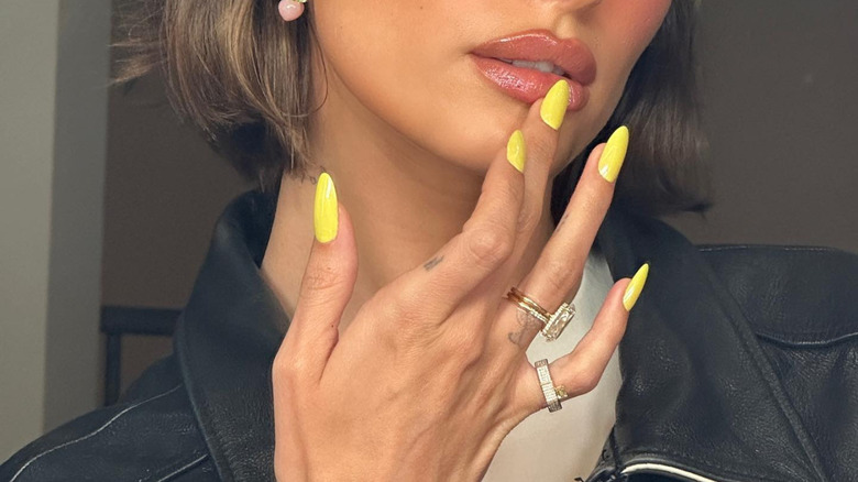Hailey Bieber with yellow nails