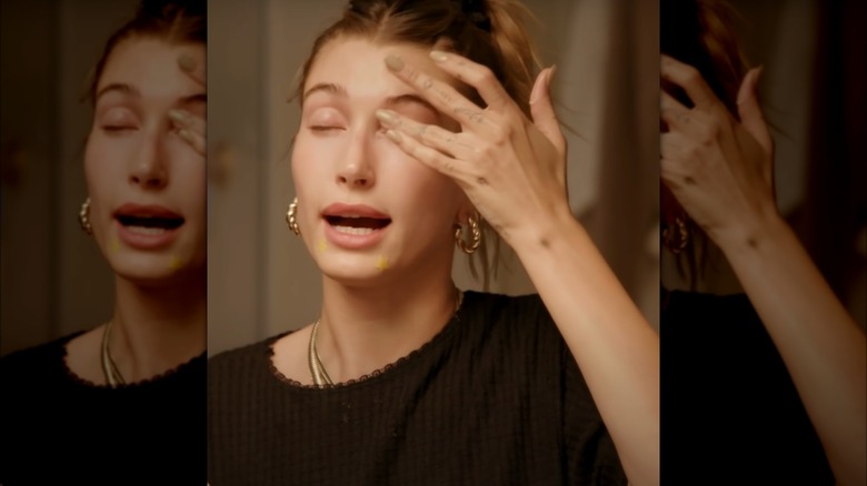 Hailey Bieber applying eye cream