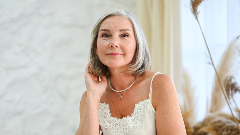 Woman with gray hair posing with a bob haircut