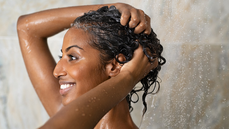Woman rinsing her hair