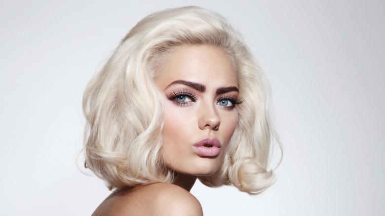 Blonde woman with dark eyebrows