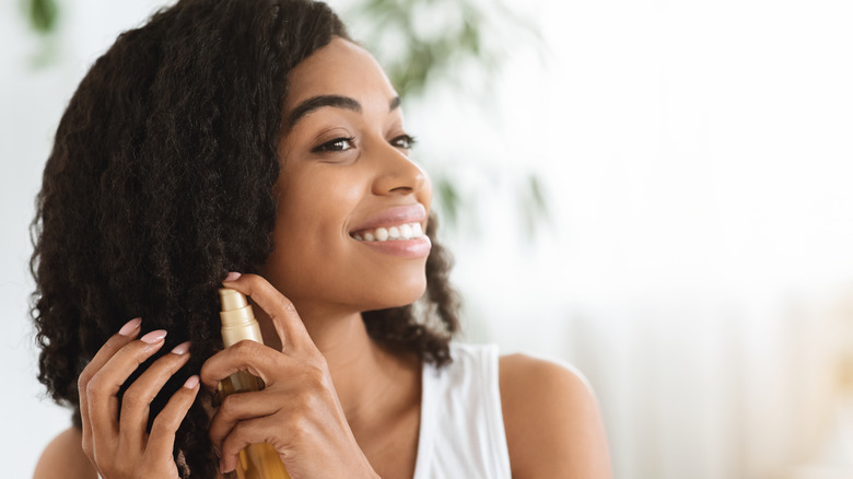 woman applying hair product