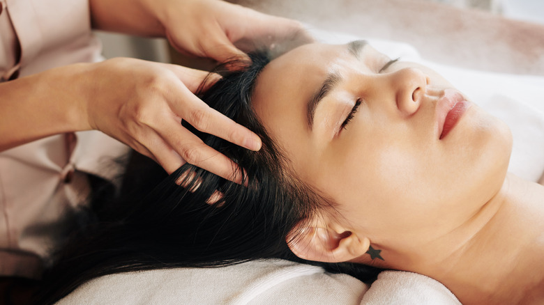 Woman having her scalp massaged