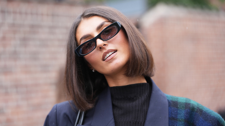 A woman with a sleek blunt brunette bob