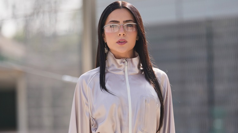 A woman with a straight sleek hairstyle and glasses