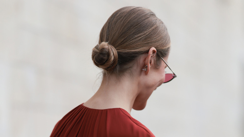 A woman with a slicked-back bun