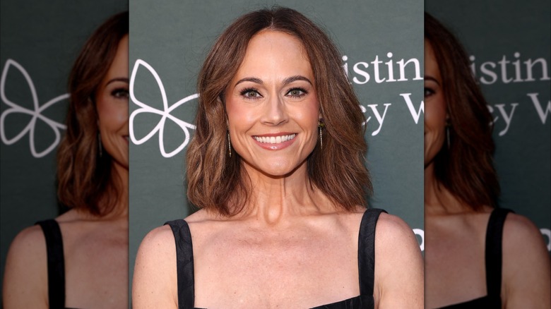 Nikki DeLoach smiles in a black dress