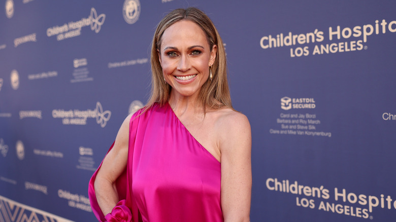 Nikki DeLoach in a one-shoulder pink dress