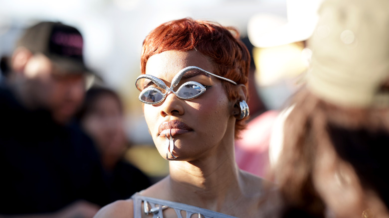 Teyana Taylor with silver sunglasses and chunky silver earrings