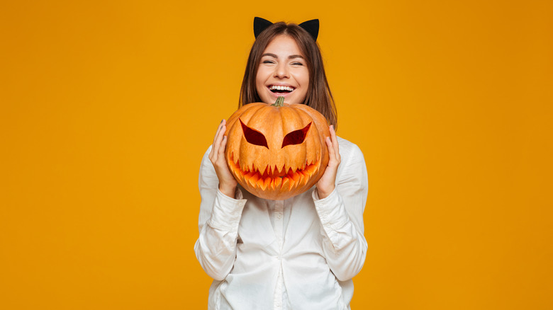 brunette with carved pumpkin