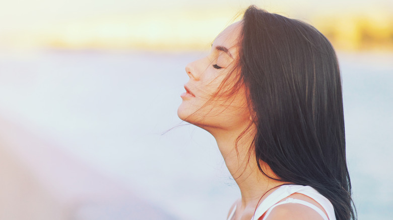 side profile of serene woman standing outside