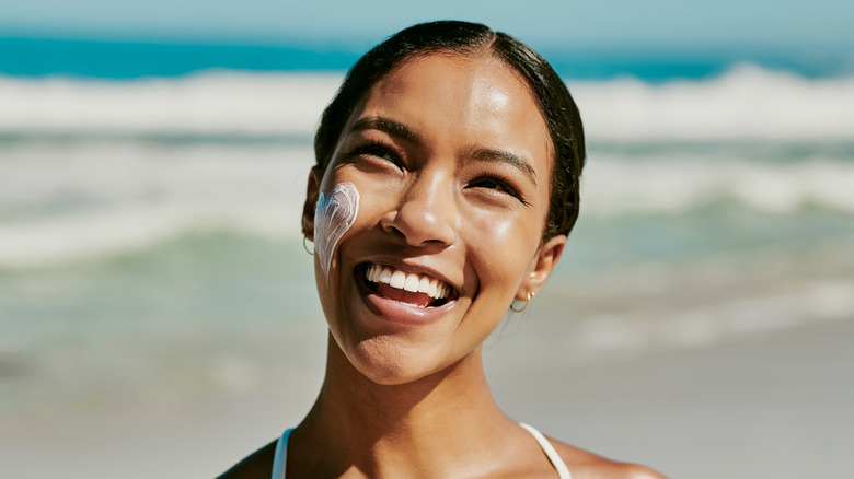 Woman wearing sunscreen on beach