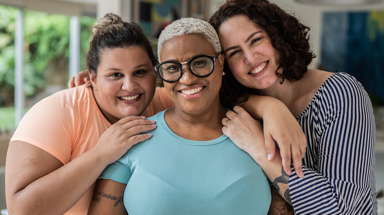 Three friends smiling together