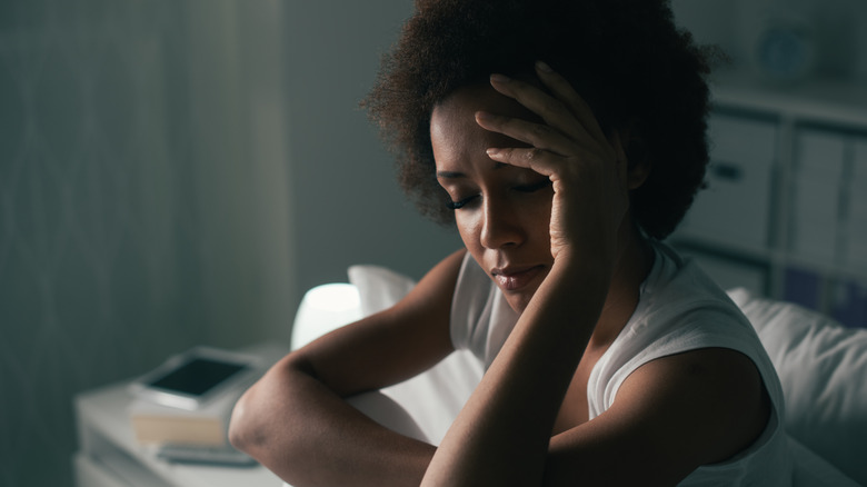 Stressed woman in bed