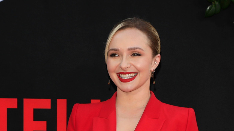 Hayden Panettiere wearing a red suit and red lipstick with her hair pulled back at a Netflix event