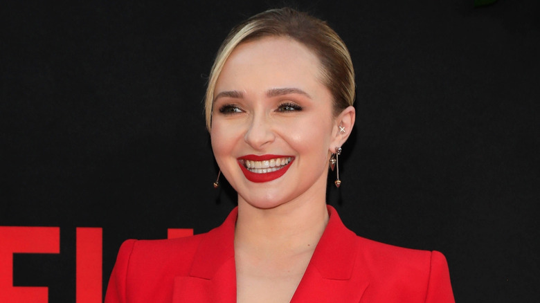 Hayden Panettiere wearing a red suit and red lipstick with her hair pulled back at a Netflix event