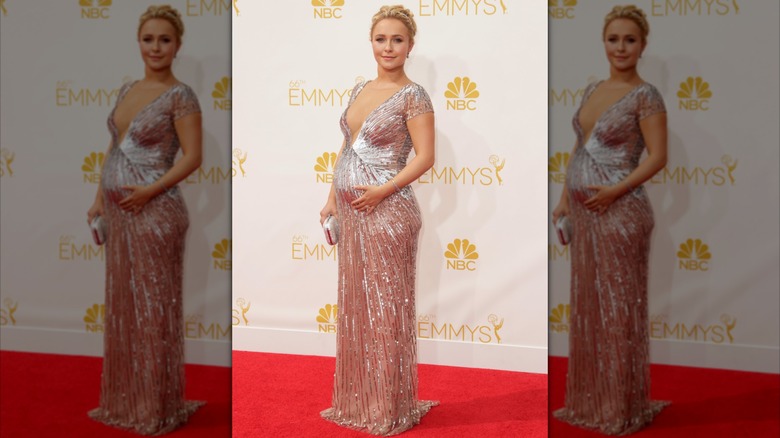 Hayden Panettiere posing in an ethereal silver-pink gown with a baby bump in August 2014.