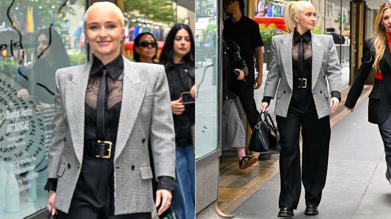 Hayden Panettiere wearing loose black pants with a black top and sheer black shirt, with a statement belt and gray blazer in September 2024.