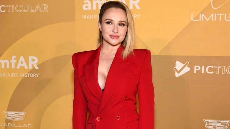 Hayden Panettiere wearing a red suit dress with her hair combed to the side at the amfAR gala in Hollywood in November 2022.