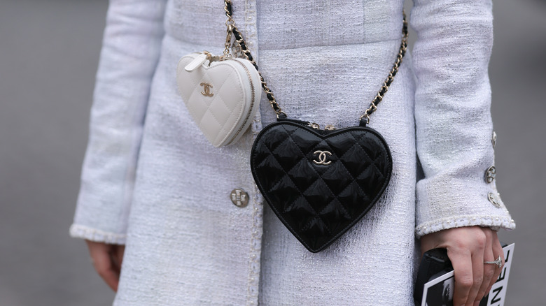 woman wearing two heart purses