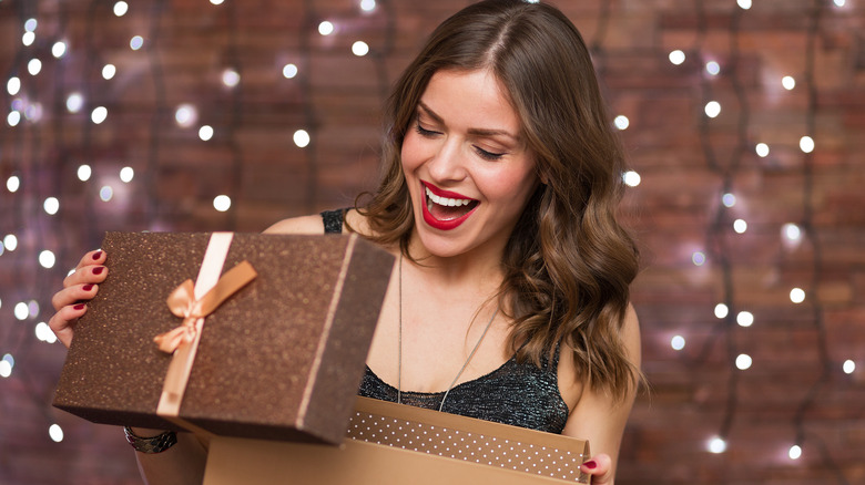 A woman opening a gift
