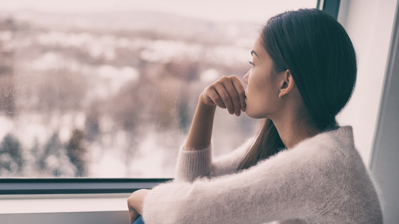 Woman looking out window