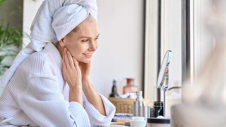 Woman doing skincare in the bathroom