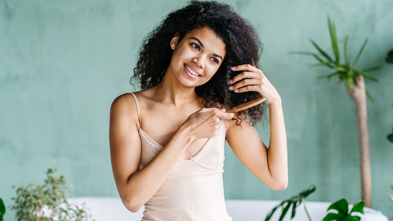 Woman pulling a comb through hair