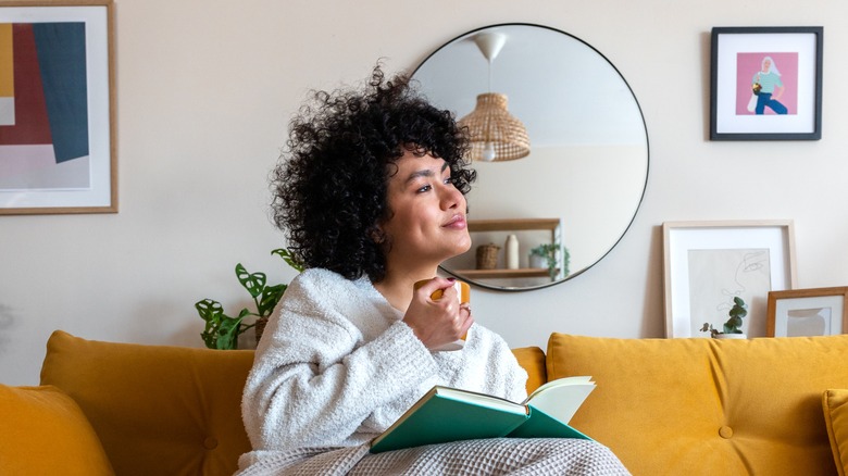 woman reading book and smiling