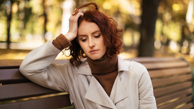 sad woman on park bench