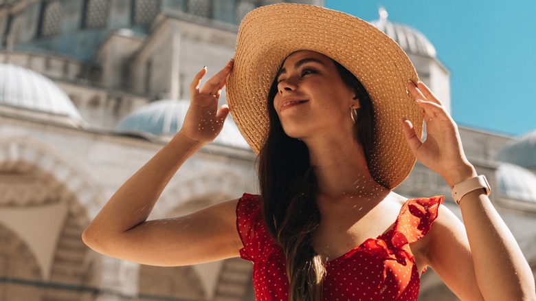 female wearing straw hat