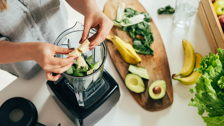 person making healthy smoothie