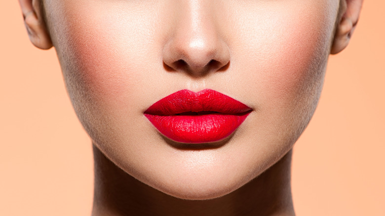 closeup of woman wearing a bright red lipstick