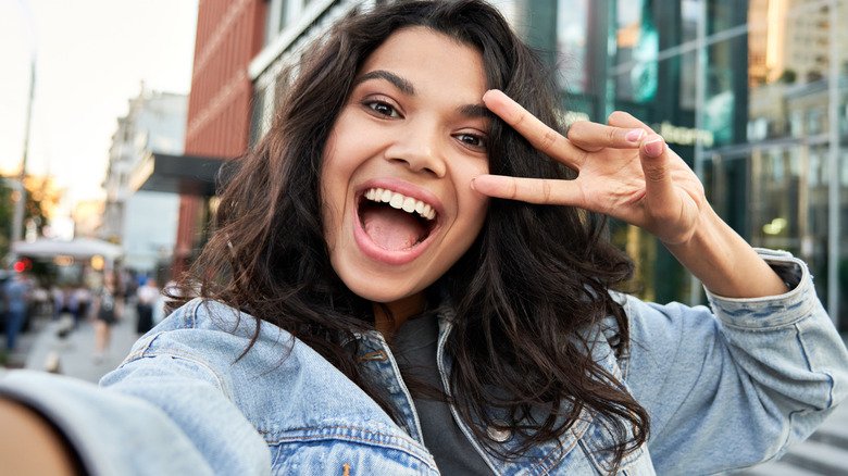 cute girl taking a selfie on the street