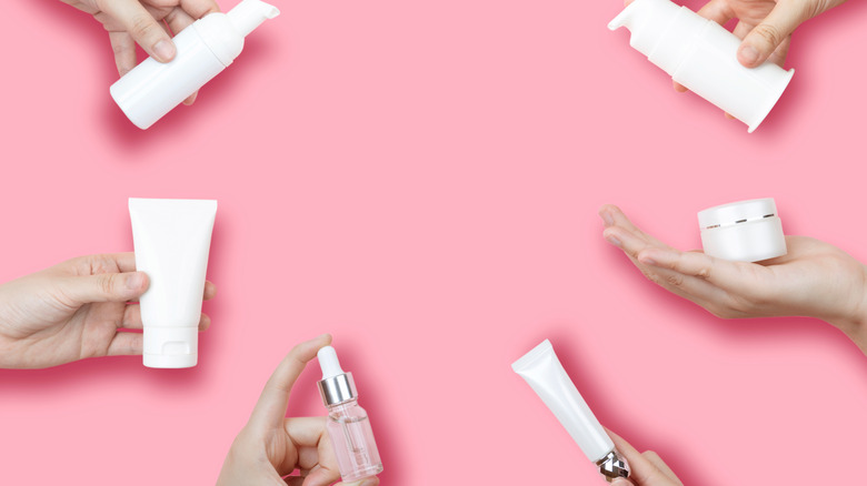 white skincare packaging on pink background