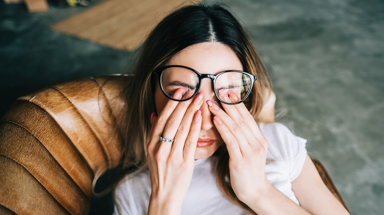 Woman rubbing eyes