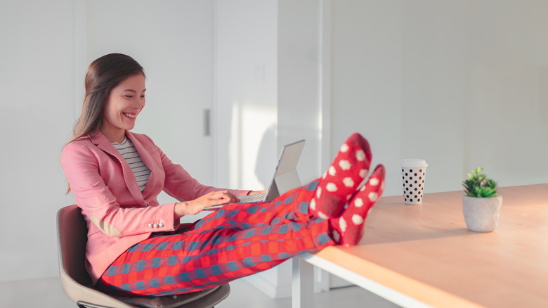 Woman wearing nice top and pajama bottoms 