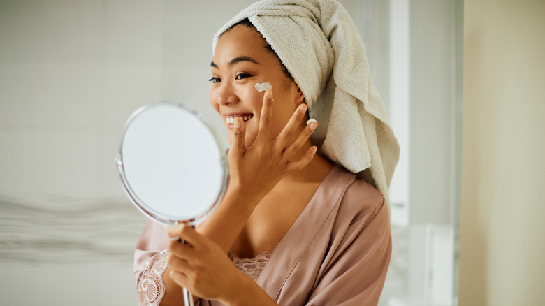 woman applying face cream