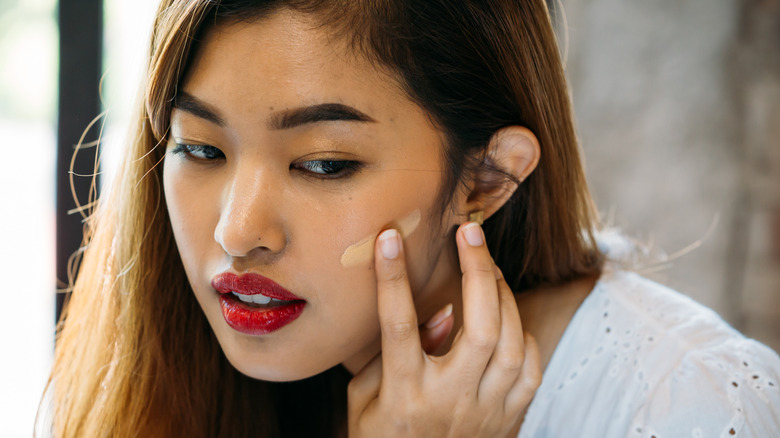 Woman applying makeup