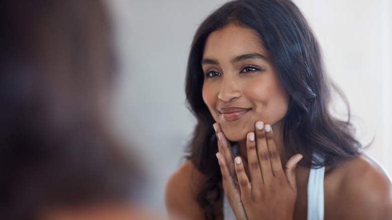 Indian woman looking in mirror