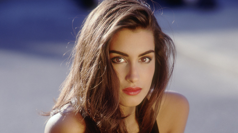 Yasmeen Ghauri models a black halter dress for Chanel in the '90s
