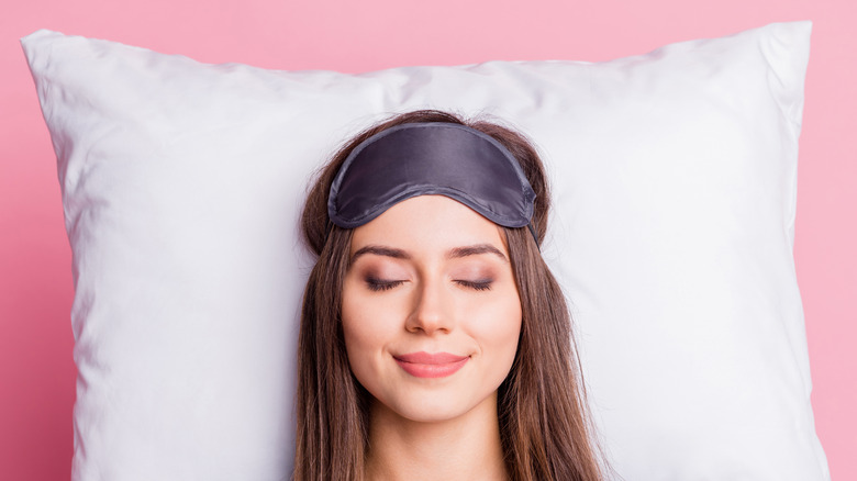 woman sleeping on white pillow