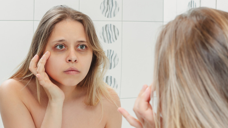 Woman looking at under eye bags