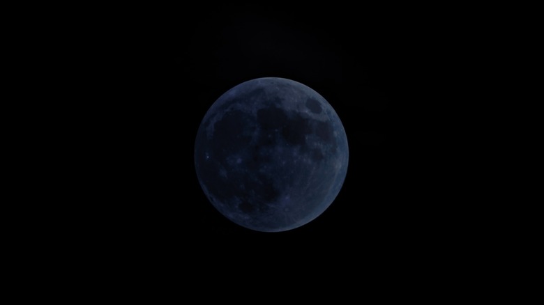 New moon in nighttime sky