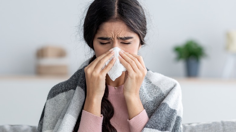 woman blowing her nose